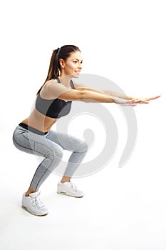 Beautiful girl exercise in sporty fashion and stretching muscles after fitness training