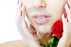 Beautiful girl face close up with a rose in hand