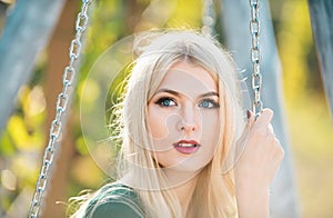 Beautiful girl face closeup, outside portrait of young woman looking eways in summer park. Summer romantic casual woman. photo