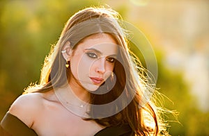 Beautiful girl face closeup, outside portrait of young woman. Summer romantic casual woman. Young woman on sunny summer