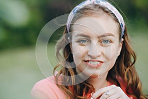 Beautiful Girl face. Perfect skin concept. Face young beautiful girl closeups short hair summer park smiling