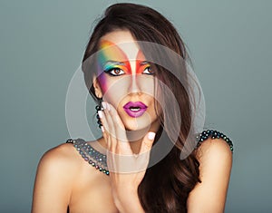 Beautiful girl with a fashion bright multicolored makeup of eyes
