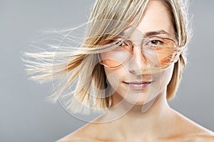 Beautiful girl fashion portrait. Glasses and windy hair