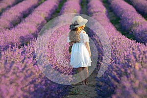 Beautiful girl in a field with lavender.