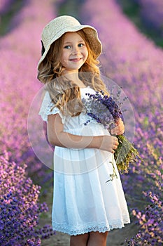 Beautiful girl in a field with lavender.