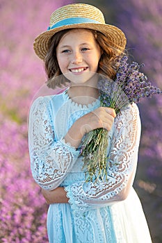 Beautiful girl in a field with lavender.