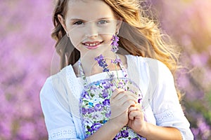 Beautiful girl in a field with lavender.