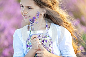 Beautiful girl in a field with lavender.