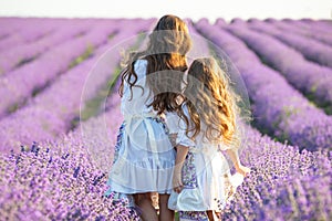 Beautiful girl in a field with lavender.