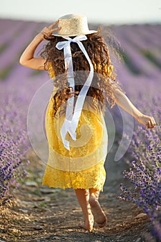 Beautiful girl in a field with lavender.