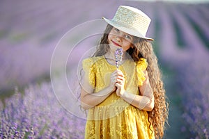 Beautiful girl in a field with lavender.