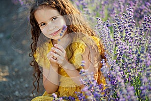 Beautiful girl in a field with lavender.