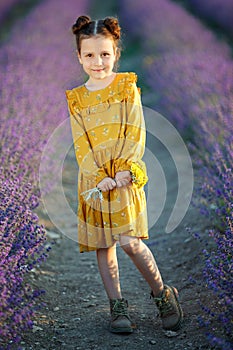 Beautiful girl in a field with lavender.