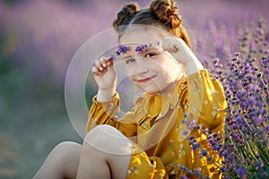 Beautiful girl in a field with lavender.