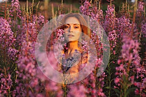 Beautiful girl in field, sun backlight, sunrise