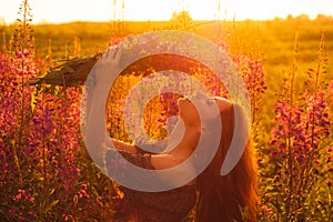 Beautiful girl on field, sun backlight, sunrise