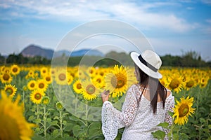 Beautiful girl in field of sunflowers