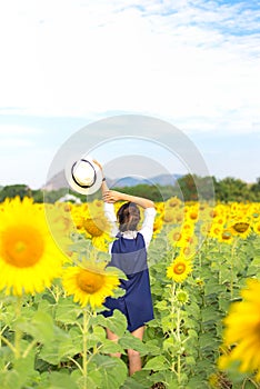 Beautiful girl in field of sunflowers,