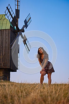 Beautiful girl field and windmill