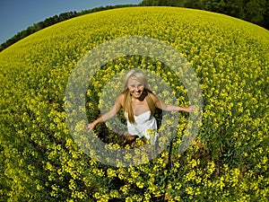 A beautiful girl in a field of yellow flowers