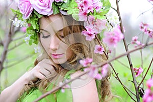 Beautiful girl in a flowered garden peach