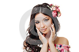 Beautiful girl with flowers. Spring woman. Lady with bright makeup and a flowering branch in her hair. Spring time