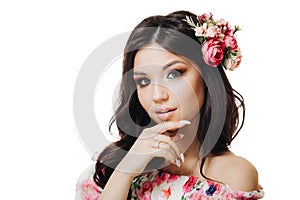 Beautiful girl with flowers. Spring woman. Lady with bright makeup and a flowering branch in her hair. Spring time