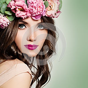 Beautiful Girl with Flowers Wreath. Long Permed Curly Hair photo