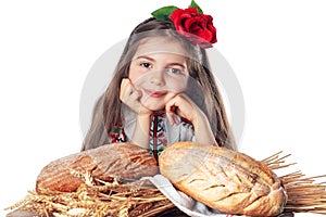 Beautiful girl and fresh homemade baked bread. Woman in traditional folklore Bulgarian costume enjoying oven baked bread from