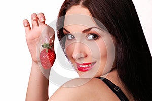 Beautiful girl with a fresh juicy strawberry