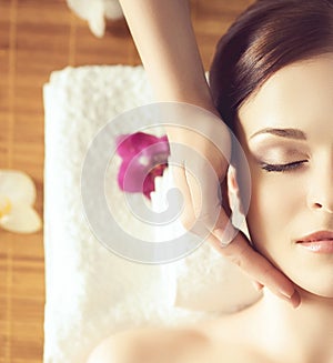 Beautiful girl getting face lifting massage in spa salon. Health care, rejuvenation and relaxation concept.