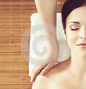 Beautiful girl getting face lifting massage in spa salon. Health care, rejuvenation and relaxation concept.