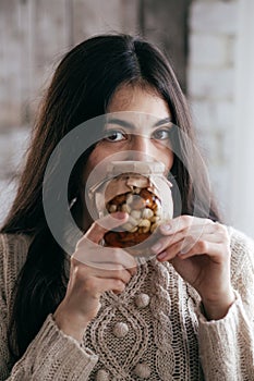 Beautiful girl a girl with jars in which honey and nuts