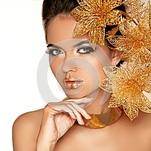 Beautiful Girl With Golden Flowers. Beauty Model Woman Face. Per