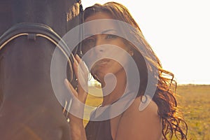 Beautiful girl in a gown with horse