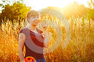 beautiful girl in the grass at sunset