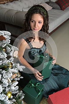 Beautiful girl in a green dress, with black curls