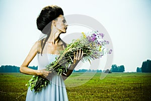 Beautiful girl in green field