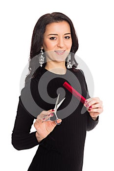 Beautiful girl hairdresser holding scissors and comb