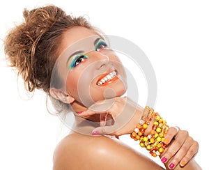 Beautiful girl with handmade bracelet and artistic makeup