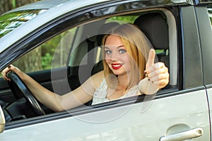 Beautiful girl is happy with purchase car