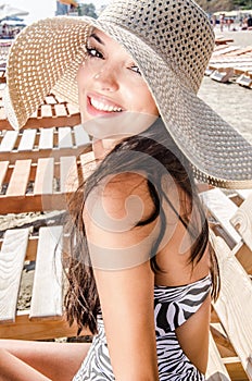 Beautiful girl with hat at the beach