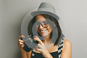 Beautiful girl in a hat with camera.
