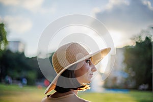 beautiful girl in a hat. Close-up portrait of a beautiful smiling girl with brown hair in a hat while walking on the street