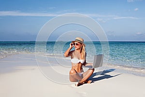 Beautiful girl have a seasonal winter vacation on the beach in exotic country