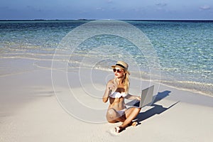 Beautiful girl have a seasonal winter vacation on the beach in exotic country