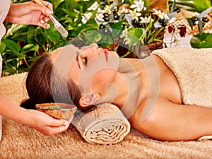 Beautiful girl having clay facial mask