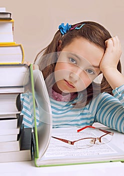 Beautiful girl having a lot of homework photo