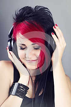 Beautiful girl with headphones enjoying listening to the music
