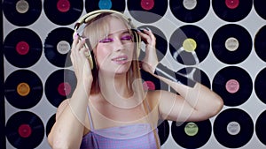 Beautiful girl in headphones sings. Singer, dj